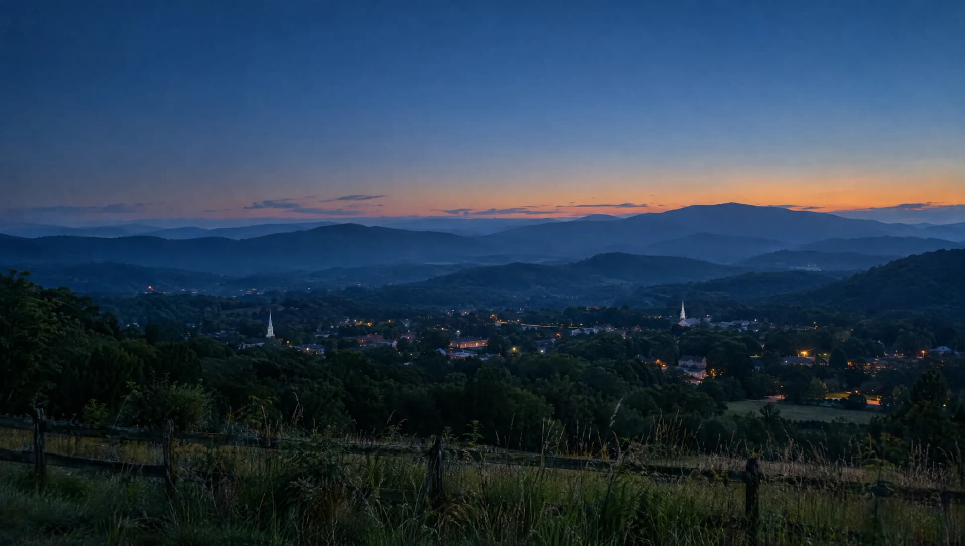The Upstate foothills at dusk, with town lights and church steeples in the valley